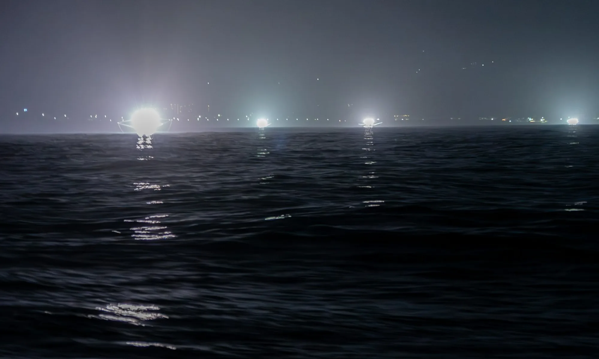 Fishing lights on the open sea at night